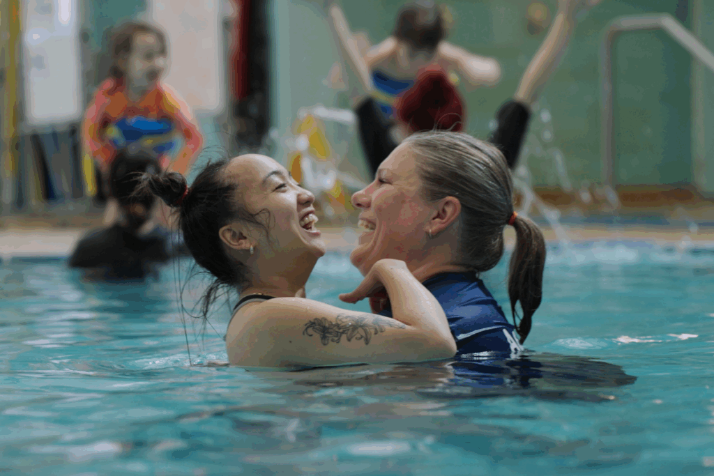 two women in a pool smiling