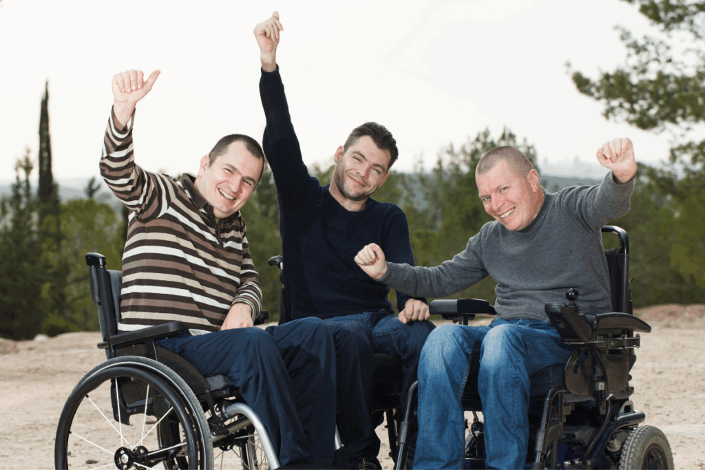 three men in wheelchairs enjoying the outdoors