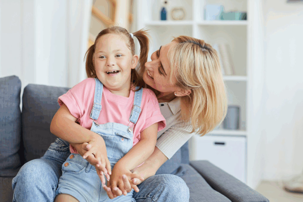 mother with her daughter who has Down syndrome. they are laughing and smiling