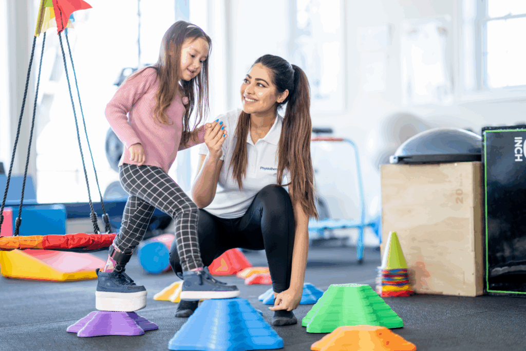 Child stepping onto blocks in physical therapy session