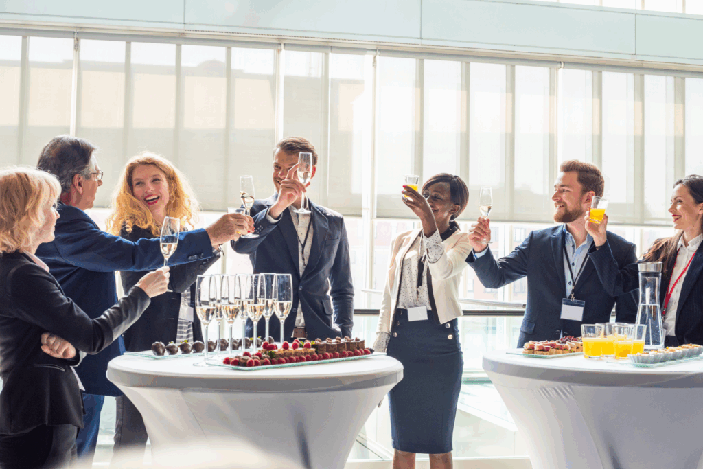 a group of professional men and women celebrating with champaign