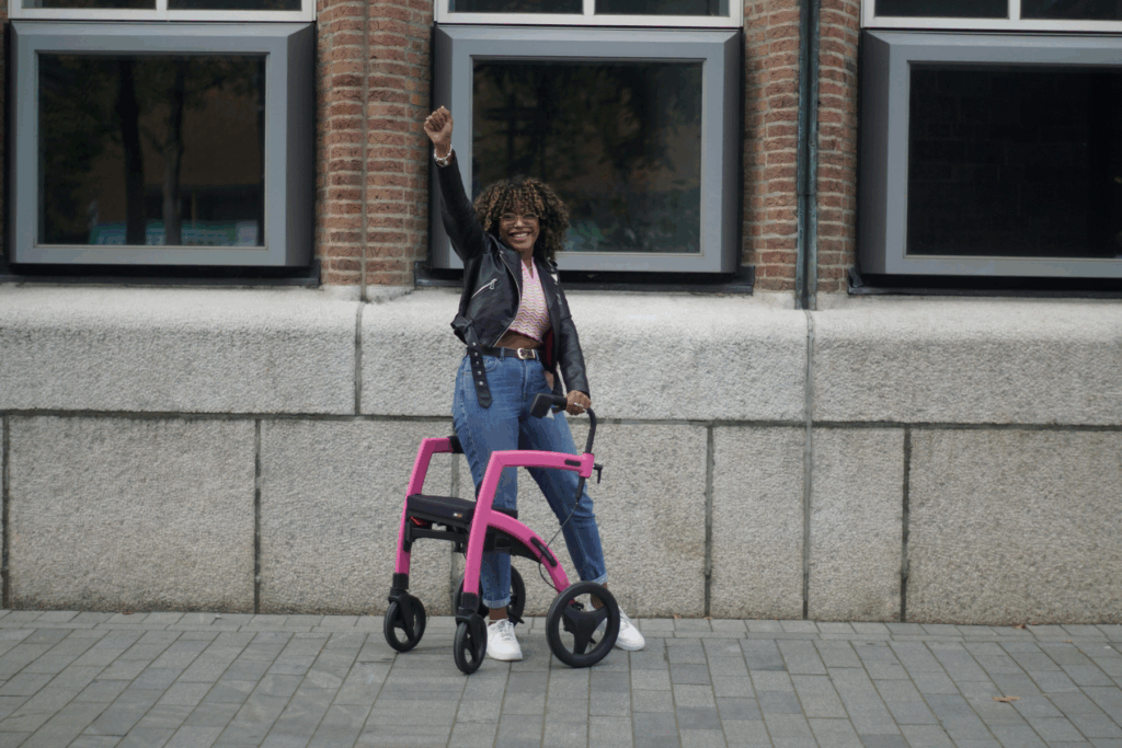 Woman standing on a sidewalk next to her mobility aid, a walker