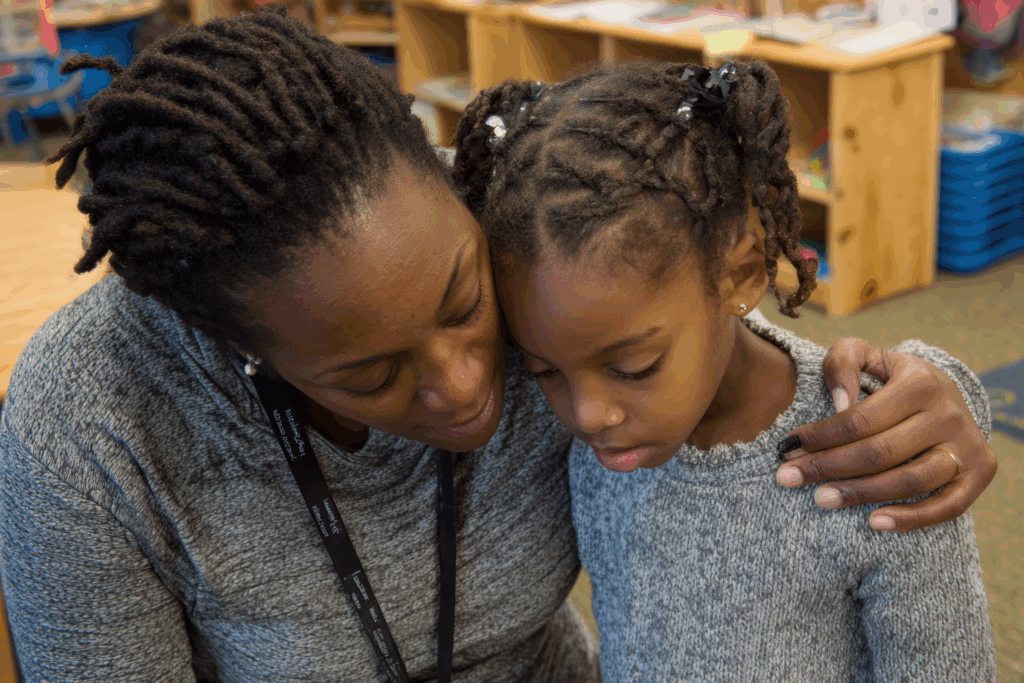 teacher comforting a student who is overwhelmed