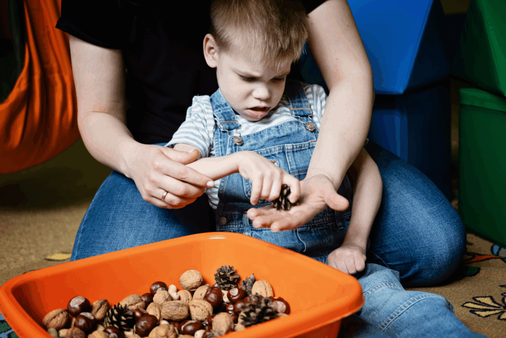 kid touching a pinecone as a sensory activity