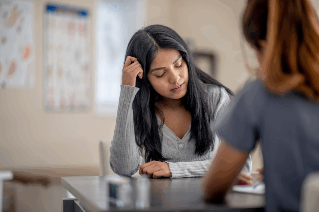 woman scratching her head and appears to be upset