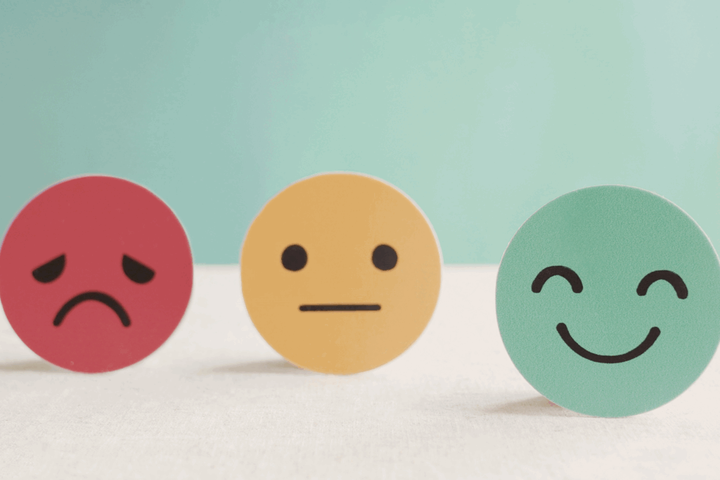 three emojis representing different emotions, happy, sad and flat
