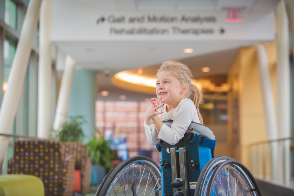 Young Girl with cerebral palsy in a wheel chair smiling in a hospital setting