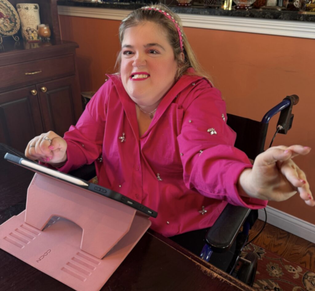 A person in a bright pink shirt using an ipad