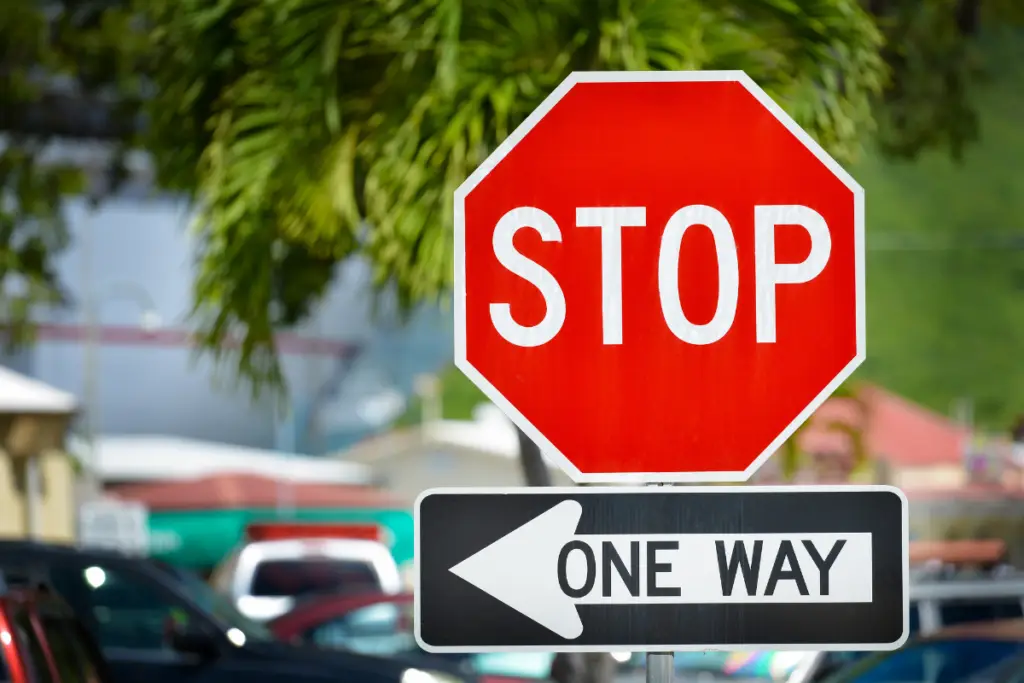 a stop sign and one way sign